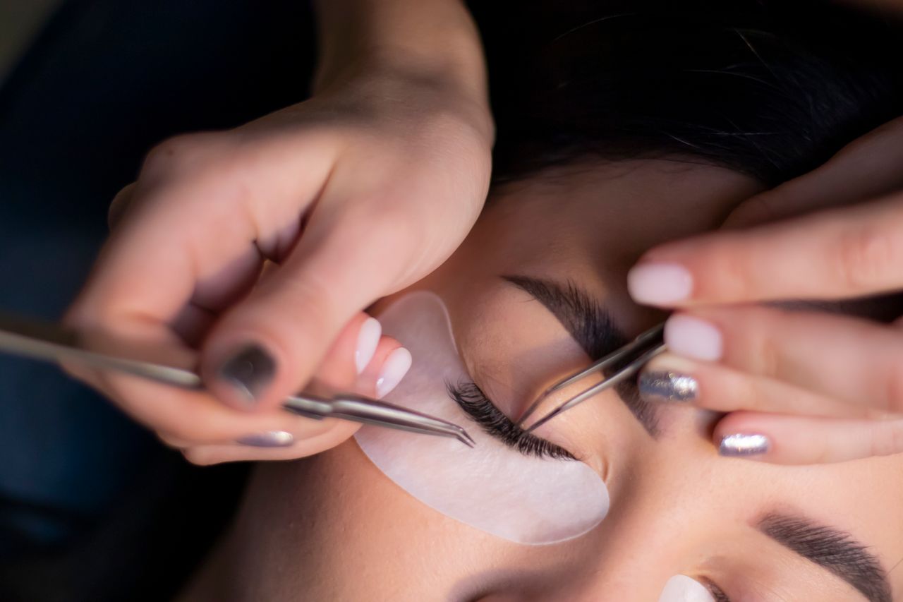 Crafting Captivating Headlines: Your awesome post title goes here Detailed view of a beautician applying eyelash extensions to a woman's eyes.